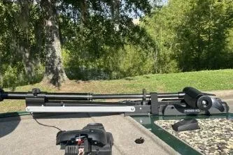 Slide: The Image of 2026 Tracker Bass Tracker Classic Limited boat with trolling motor in a scenic outdoor setting. - 3