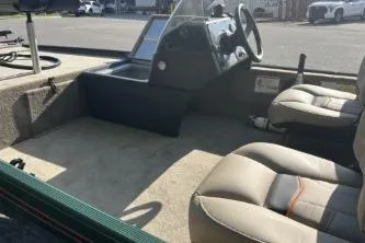 Slide: The Image of 2026 Tracker Bass Tracker Classic Limited boat interior with steering console and seating. - 2