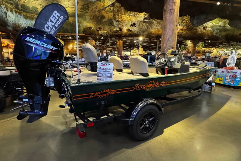 Slide: The Image of 2026 Tracker Bass Tracker Classic Limited boat displayed indoors with Mercury engine. - 47