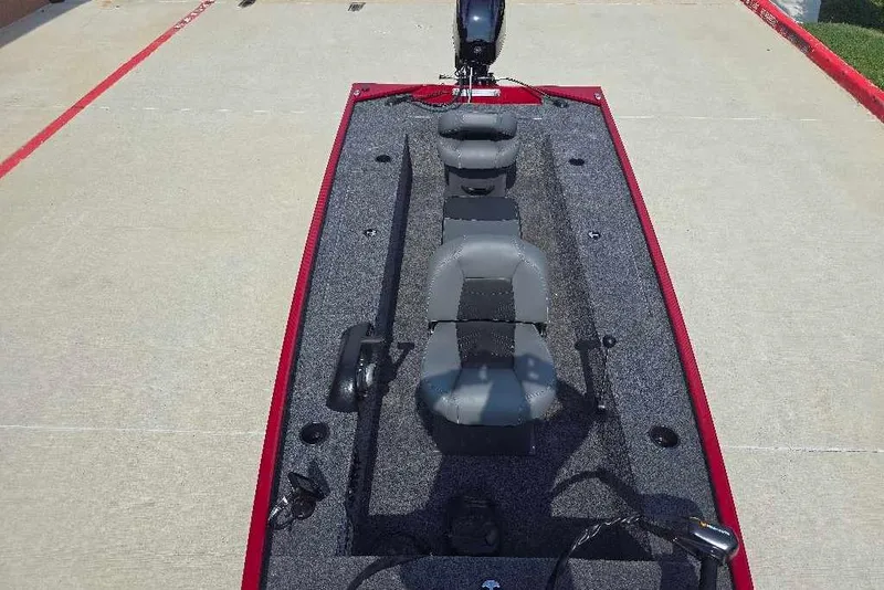 Slide: The Image of 2026 Tracker Panfish 17 boat interior with gray seating and red trim. - 13