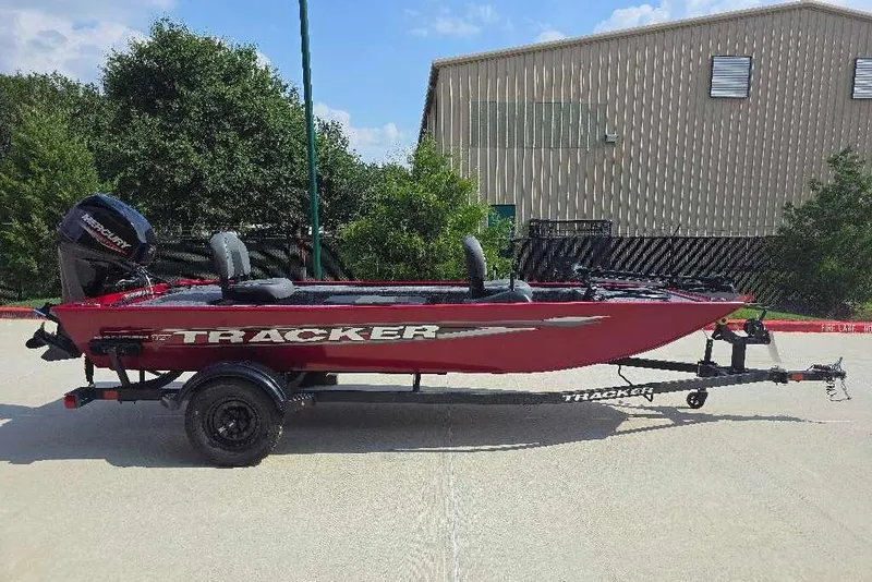 Slide: The Image of 2026 Tracker Panfish 17 boat on trailer, parked outdoors near a building. - 3