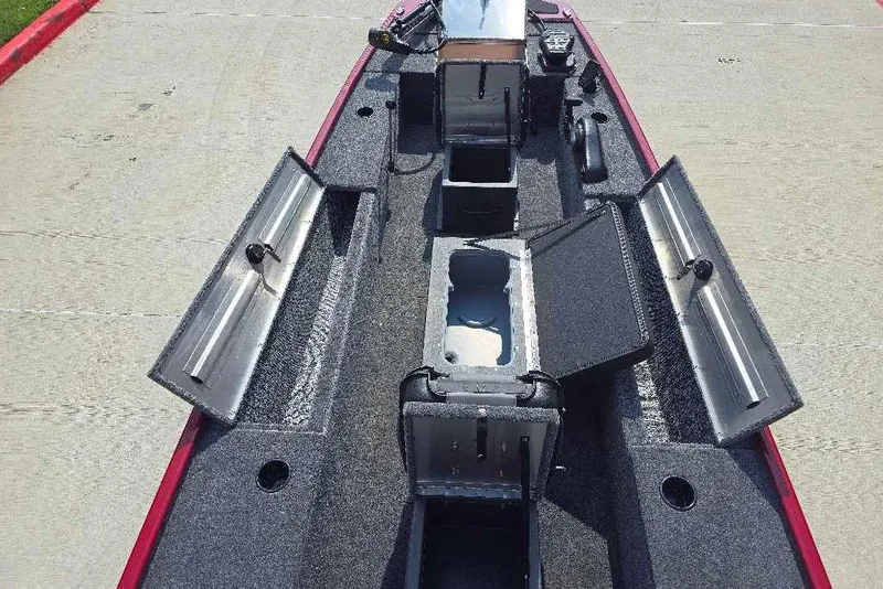 Slide: The Image of 2026 Tracker Panfish 17 boat interior with open storage compartments on a concrete surface. - 6