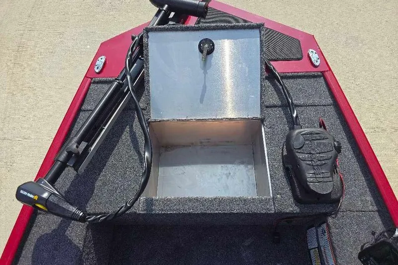 Slide: The Image of 2026 Tracker Panfish 17 boat interior with open storage compartment and trolling motor. - 7
