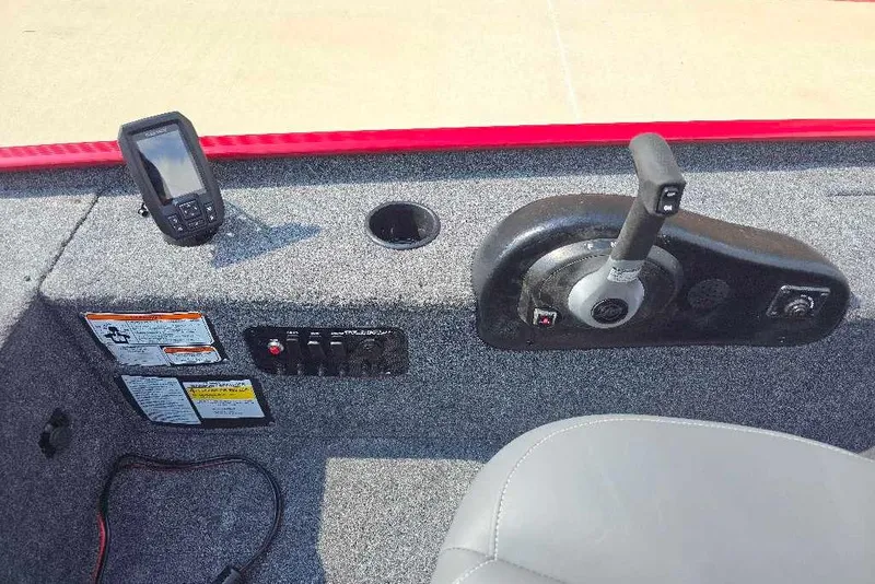 Slide: The Image of 2026 Tracker Panfish 17 boat console with controls and fish finder. - 9