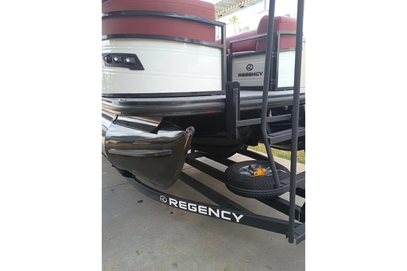 Slide: The Image of 2026 Regency 250 DL3 pontoon boat on trailer, featuring sleek design and modern accents. - 14