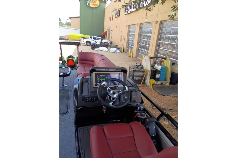 Slide: The Image of 2026 Regency 250 DL3 boat interior with red seating and modern dashboard. - 13