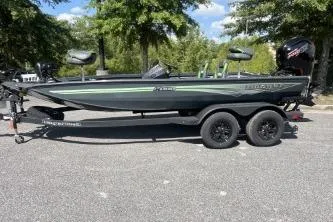 The Image of 2026 Ranger RT188P fishing boat on trailer, parked outdoors under trees. - 0