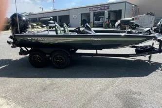 Slide: The Image of 2026 Ranger RT188P fishing boat on trailer, parked outside a building. - 2