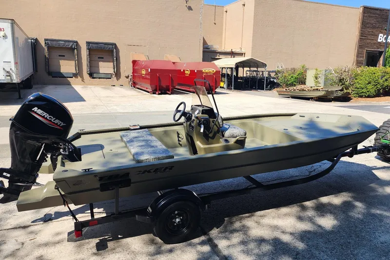 Slide: The Image of 2026 Tracker Grizzly 1860 CC boat with Mercury engine in a parking lot. - 2