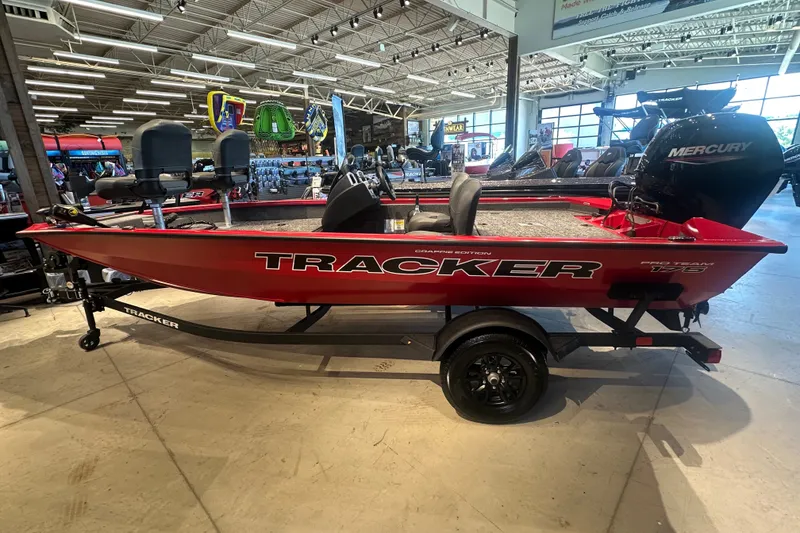 The Image of 2026 Tracker Pro Team 175 Crappie Edition boat in showroom, featuring Mercury engine. - 0
