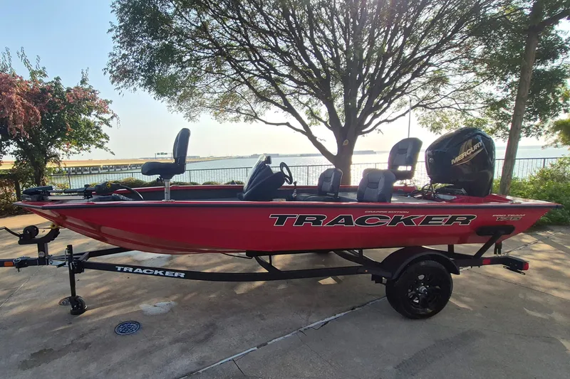 The Image of 2026 Tracker Pro Team 175 Crappie Edition boat, red, parked near waterfront. - 0