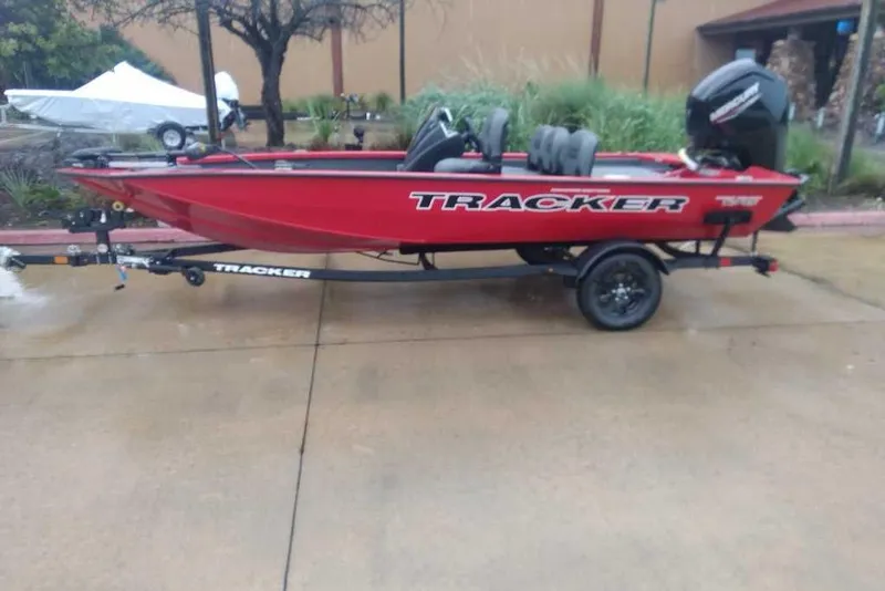 The Image of 2026 Tracker Pro Team 175 Crappie Edition boat on trailer, red exterior, parked outdoors. - 0