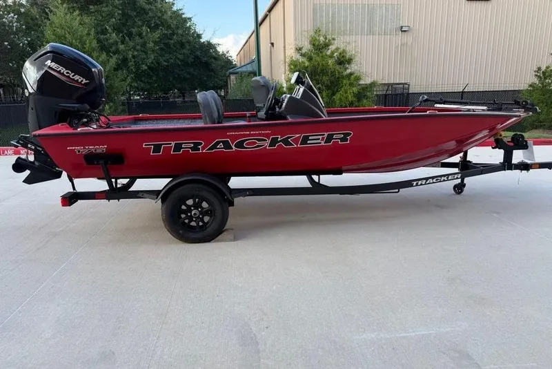 Slide: The Image of 2026 Tracker Pro Team 175 Crappie Edition boat on trailer, red with Mercury engine. - 62