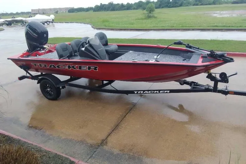 Slide: The Image of 2026 Tracker Pro Team 175 Crappie Edition boat on trailer, parked on wet pavement. - 8