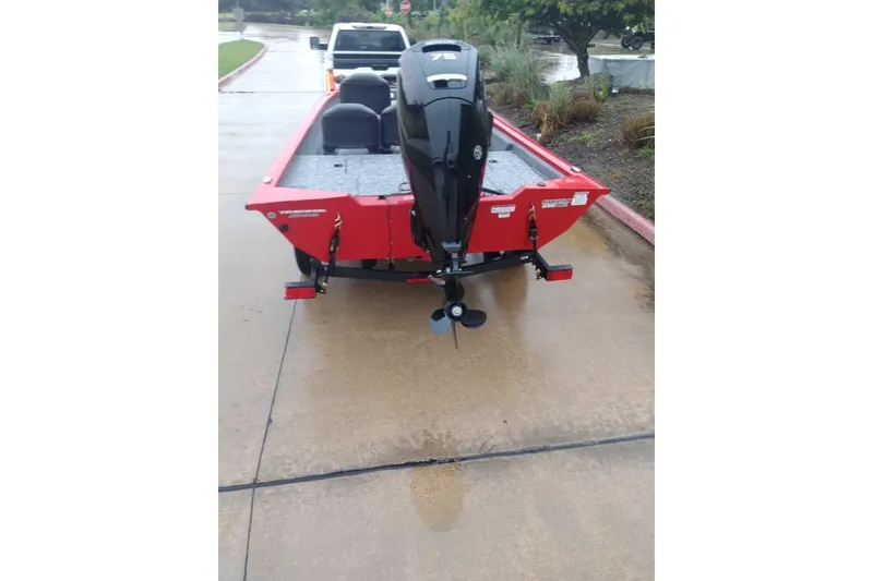 Slide: The Image of 2026 Tracker Pro Team 175 Crappie Edition boat on wet pavement, rear view. - 10