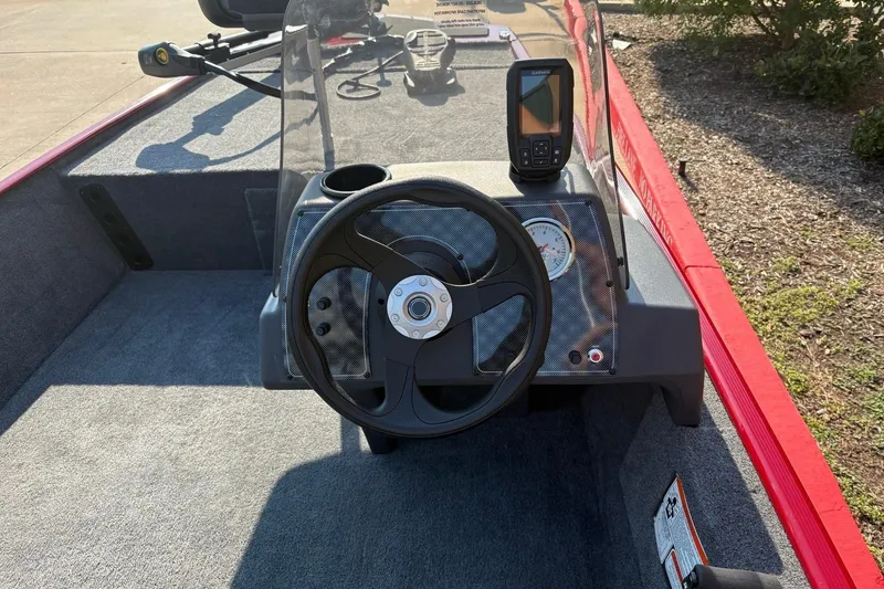 Slide: The Image of 2026 Tracker Bass Tracker Classic XL boat dashboard with steering wheel and fish finder. - 4