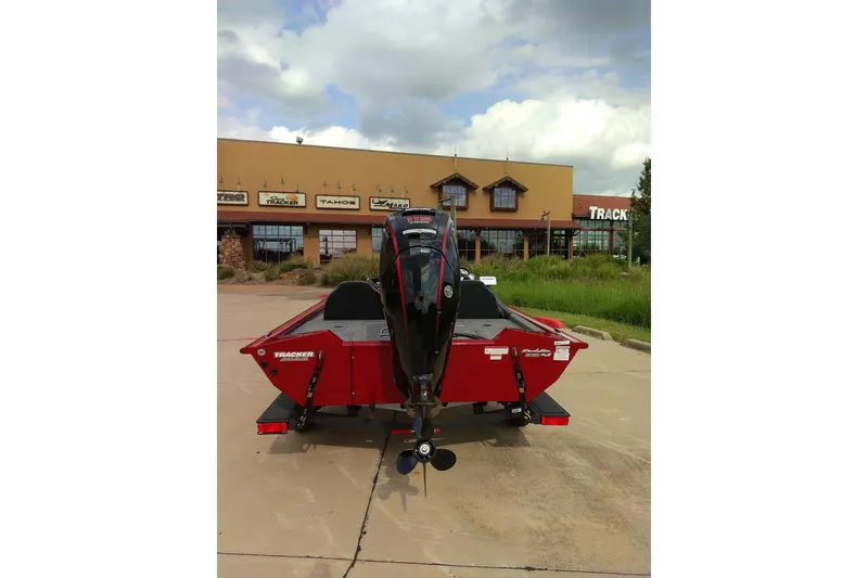 Slide: The Image of 2026 Tracker Bass Tracker Classic XL boat parked outside a dealership under cloudy skies. - 7