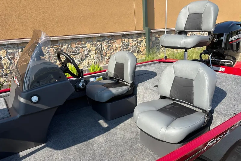 Slide: The Image of 2026 Tracker Bass Tracker Classic XL boat interior with three gray seats and steering console. - 3