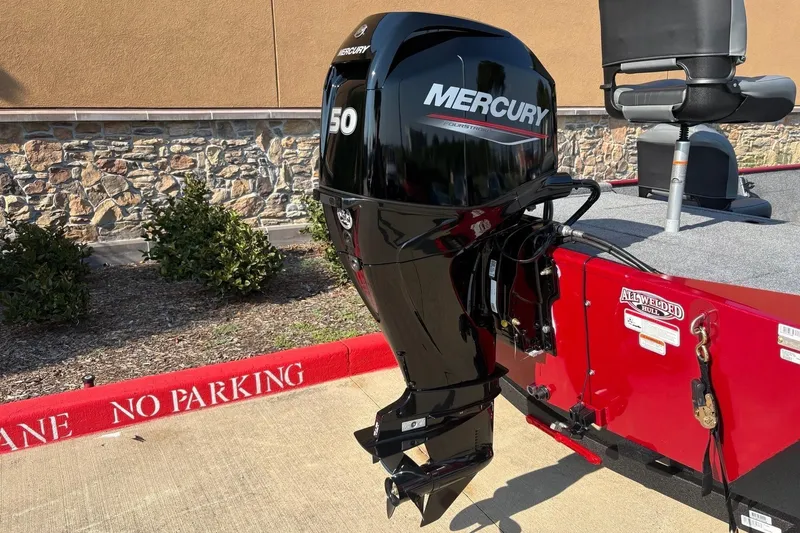 Slide: The Image of 2026 Tracker Bass Tracker Classic XL with Mercury 50 outboard motor, parked near "No Parking" zone. - 5
