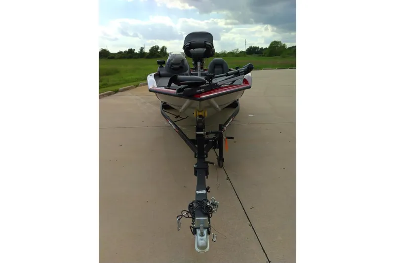 Slide: The Image of 2026 Tracker Bass Tracker Classic XL boat on trailer, parked on concrete with grassy background. - 9