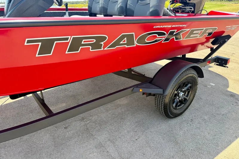 Slide: The Image of 2026 Tracker Pro Team 175 Crappie Edition boat, red exterior, on trailer. - 16