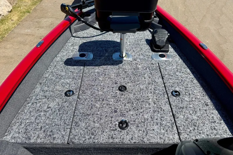 Slide: The Image of 2026 Tracker Pro Team 175 Crappie Edition boat deck with gray carpet and red trim. - 13