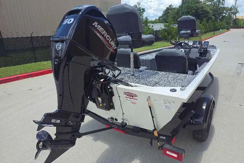 Slide: The Image of 2026 Tracker Pro 170 boat with Mercury engine, parked outdoors on a sunny day. - 4