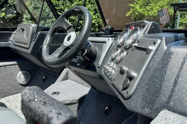 Slide: The Image of 2026 Tracker Pro Guide V-175 WT boat dashboard with steering wheel and instrument panel. - 6