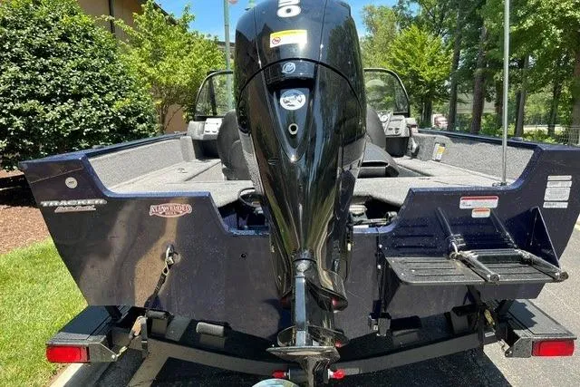 Slide: The Image of 2026 Tracker Pro Guide V-175 WT boat with powerful outboard motor, parked outdoors. - 72