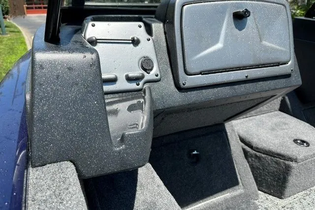 Slide: The Image of Close-up of the helm area of a 2026 Tracker Pro Guide V-175 WT with a gray dashboard. - 12