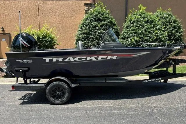 Slide: The Image of 2026 Tracker Pro Guide V-175 WT boat on trailer, parked outdoors. - 2