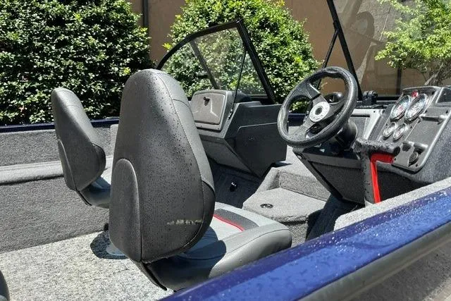 Slide: The Image of 2026 Tracker Pro Guide V-175 WT boat interior with steering wheel and seats. - 71