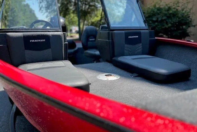 Slide: The Image of 2026 Tracker Pro Guide V-175 Combo boat interior with red exterior and black seating. - 5