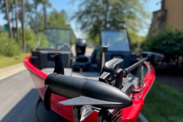 Slide: The Image of 2026 Tracker Pro Guide V-175 Combo boat with red exterior and trolling motor. - 2
