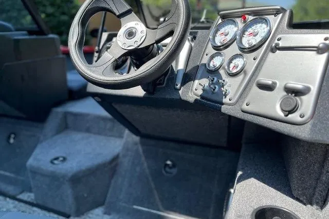 Slide: The Image of 2026 Tracker Pro Guide V-175 Combo boat dashboard with steering wheel and gauges. - 7