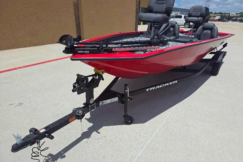 Slide: The Image of 2026 Tracker Pro Team 190 boat in red on a trailer, parked outdoors. - 5
