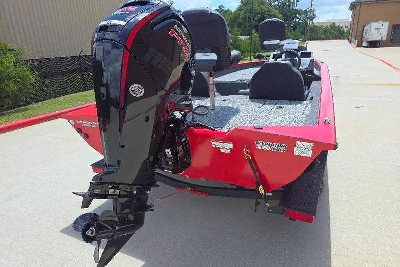 Slide: The Image of 2026 Tracker Pro Team 190 boat with powerful outboard motor, red exterior, parked outdoors. - 2