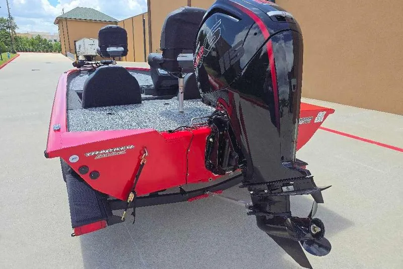 Slide: The Image of 2026 Tracker Pro Team 190 boat with powerful outboard motor, red and black design. - 3