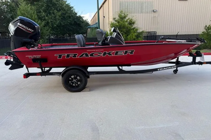 Slide: The Image of 2026 Tracker Pro Team 175 Crappie Edition boat on trailer, red exterior, parked outdoors. - 3