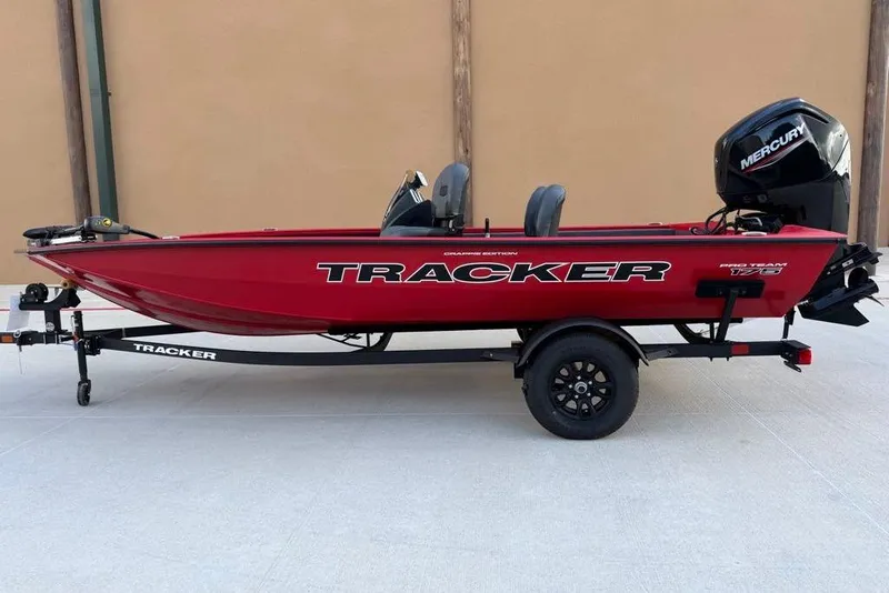 The Image of 2026 Tracker Pro Team 175 Crappie Edition boat, red, on trailer with Mercury engine. - 0