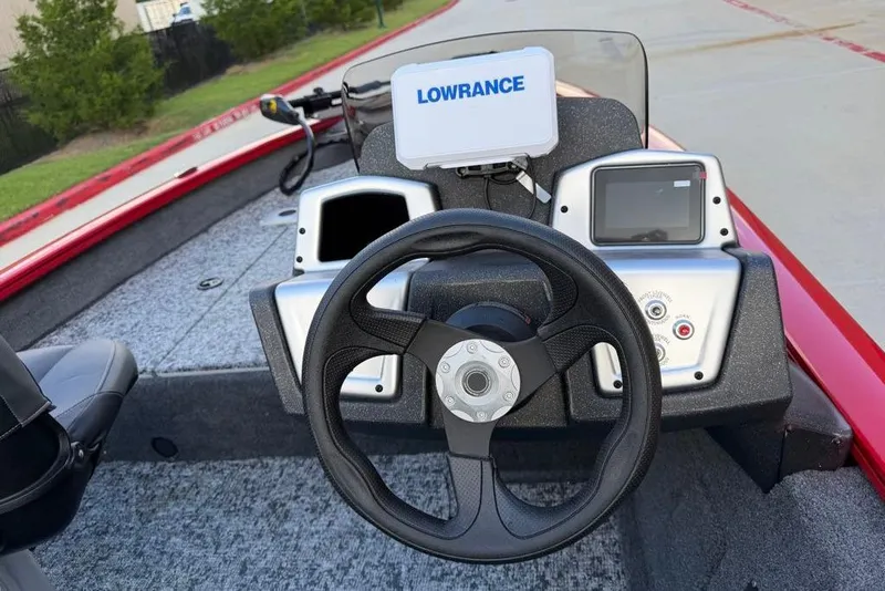 Slide: The Image of 2026 Tracker Pro Team 175 Crappie Edition boat dashboard with steering wheel and navigation system. - 9