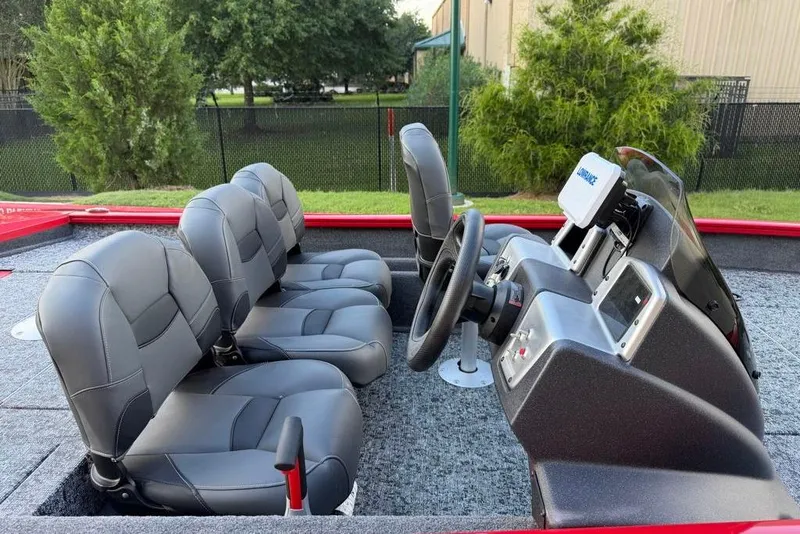 Slide: The Image of 2026 Tracker Pro Team 175 Crappie Edition boat interior with gray seating and steering console. - 17