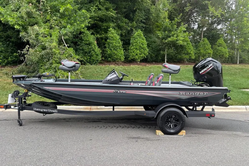 The Image of 2026 Ranger RT178 fishing boat with Mercury engine on trailer, parked on road. - 0