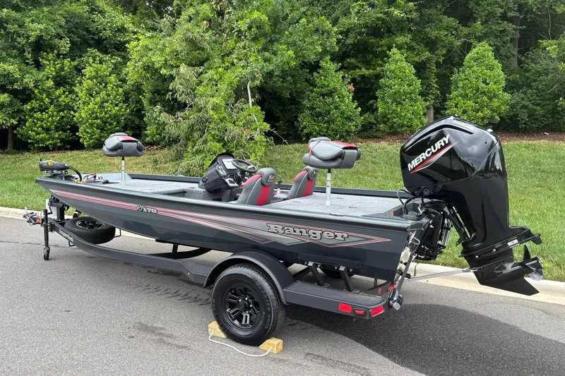 Slide: The Image of 2026 Ranger RT178 boat with Mercury engine on trailer, parked near lush greenery. - 3