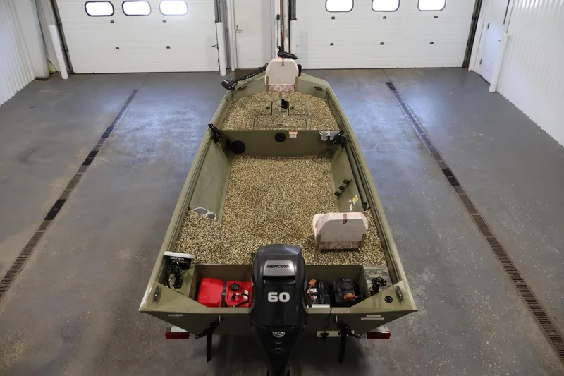 Slide: The Image of 2014 Lowe Roughneck 1756 boat in a garage, featuring a Mercury 60 engine. - 10