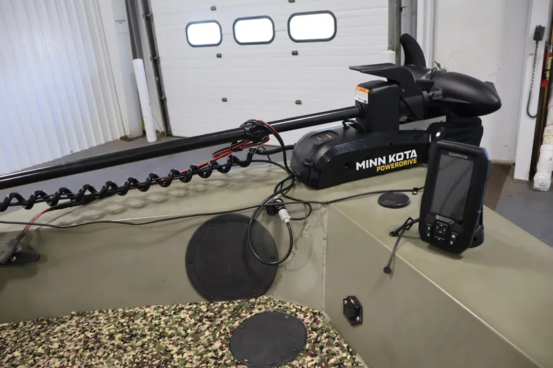 Slide: The Image of 2014 Lowe Roughneck 1756 boat with Minn Kota PowerDrive and Garmin device in a garage. - 14