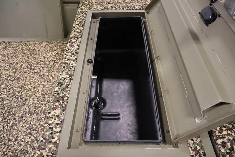 Slide: The Image of Open storage compartment in 2014 Lowe Roughneck 1756 boat with camouflage interior. - 17