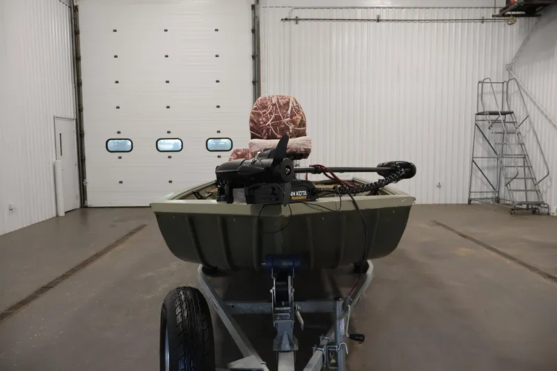 Slide: The Image of 2014 Lowe Roughneck 1756 boat on trailer in a spacious garage. - 2