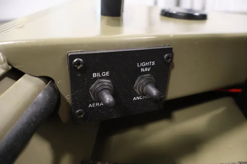 Slide: The Image of Control panel of a 2014 Lowe Roughneck 1756 boat with bilge and navigation switches. - 22