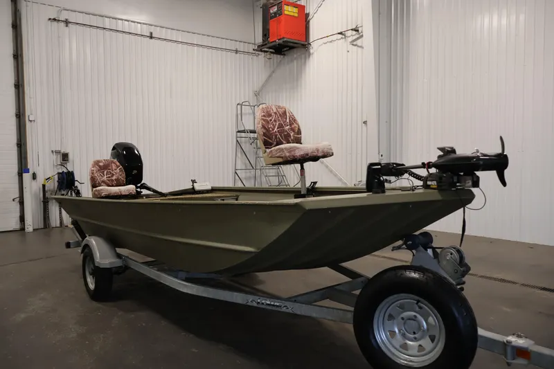 Slide: The Image of 2014 Lowe Roughneck 1756 boat on trailer in indoor storage facility. - 3